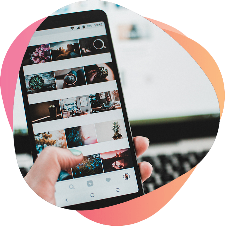 Hand holding a phone browsing Instagram